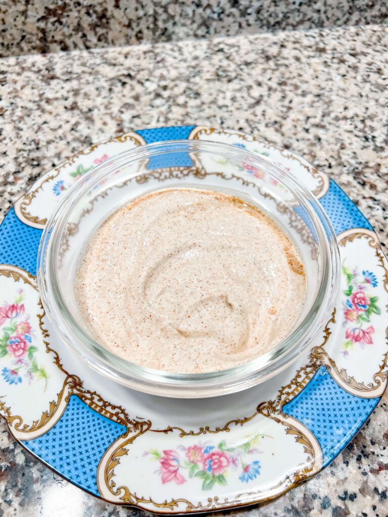 chili lime crema in a glass bowl on a blue floral china plate